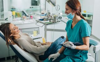 Female dentist talking to her patient