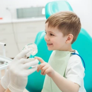 A dentist getting familiar with his young patient.