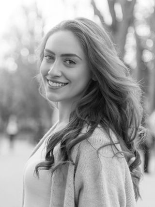 A black and white image of a smiling woman