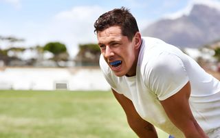 Female wearing a custom-fitted mouthguard for sport