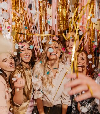 Group of colleagues celebrating with streamers and confetti