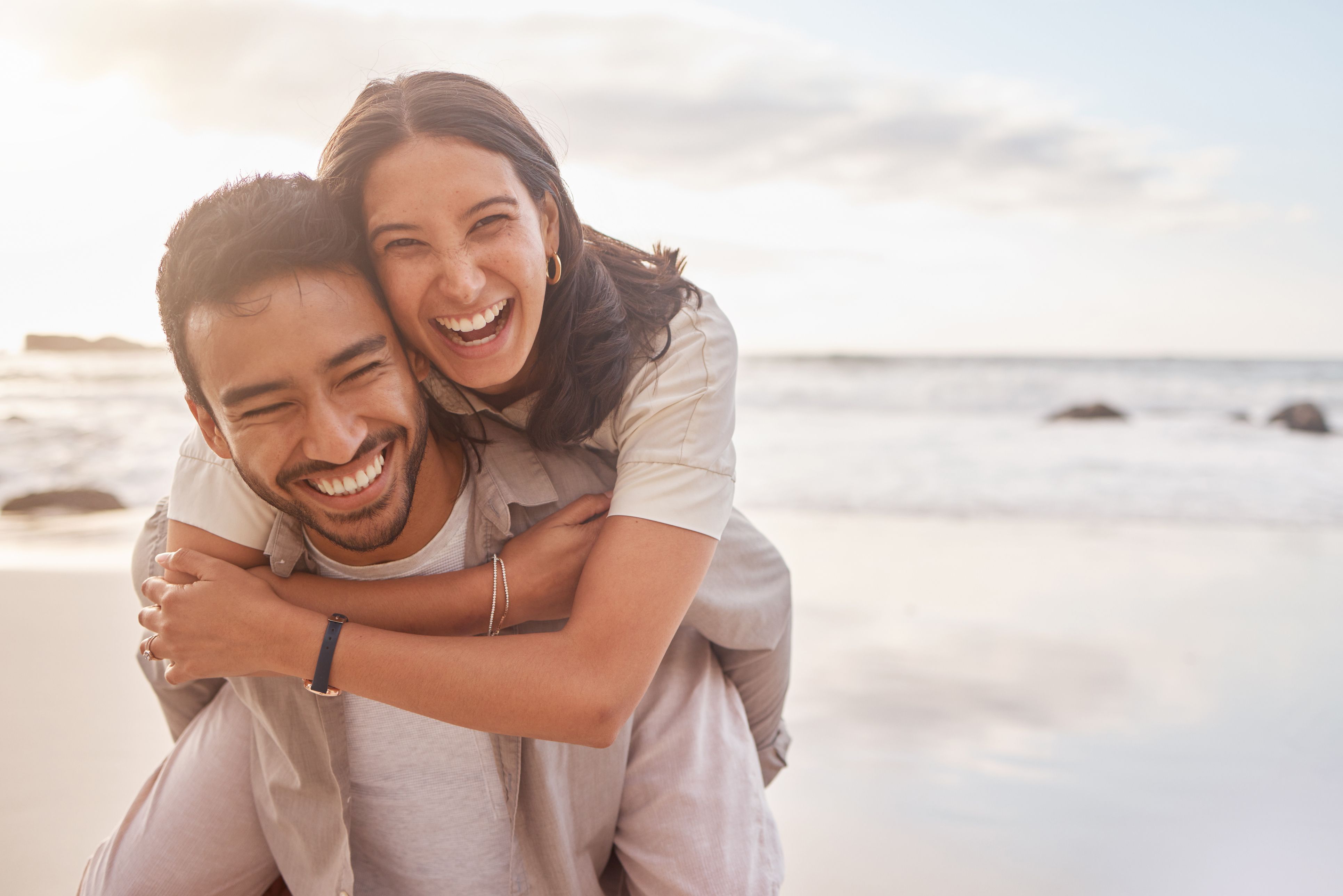 Stock image of couple smiling while at the beach