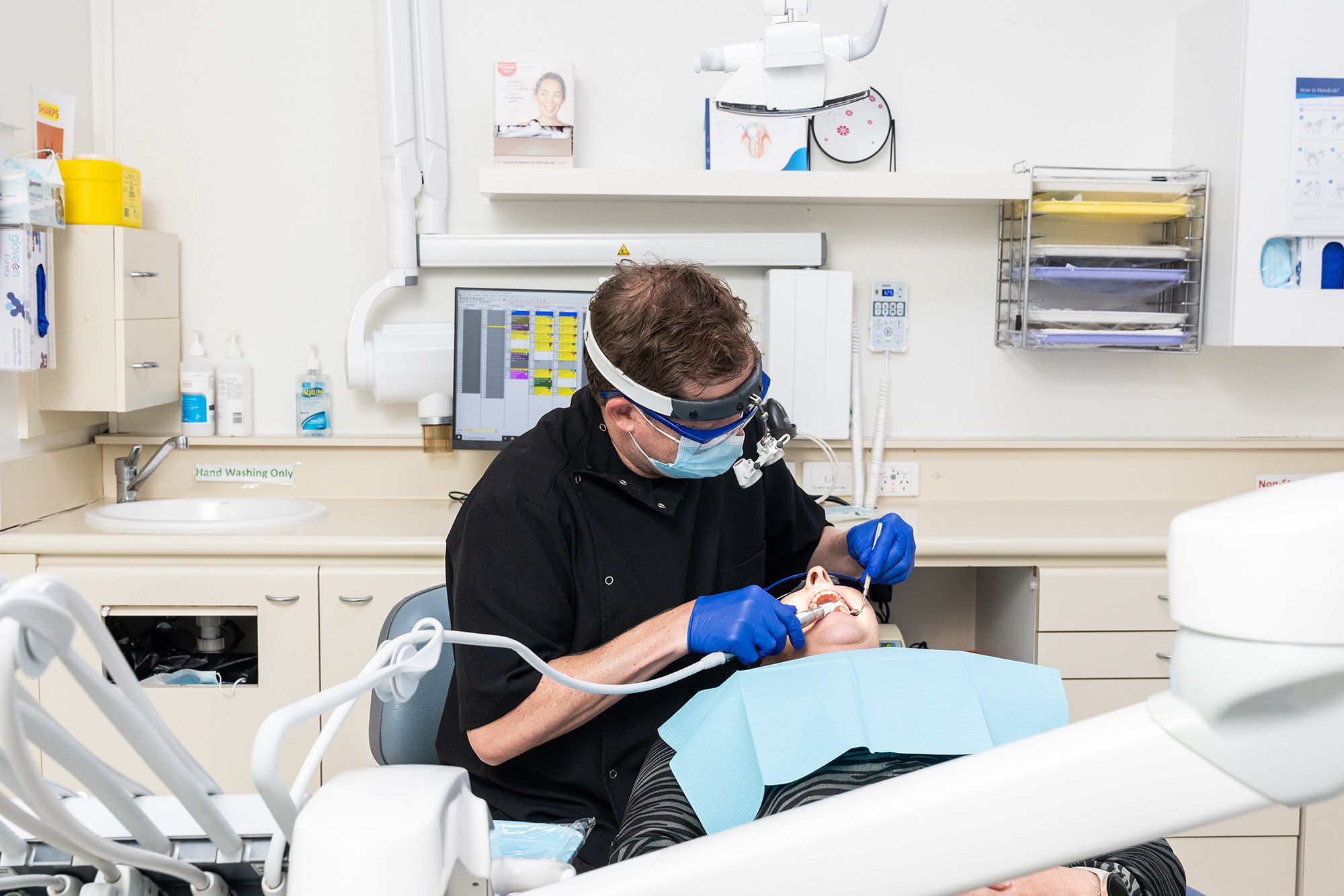 Image of a dentist performing surgery on their patient.