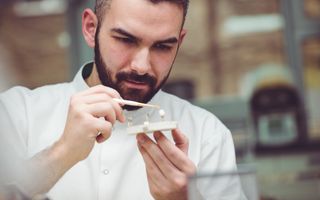 Dentist inspecting a patients dental crown prior to application