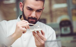 Dentist perfecting the shape of a patients crown