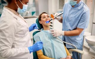 Image of a patient getting her teeth filled with her dentist.