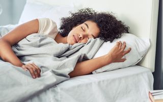 Stock image of young female asleep on her side