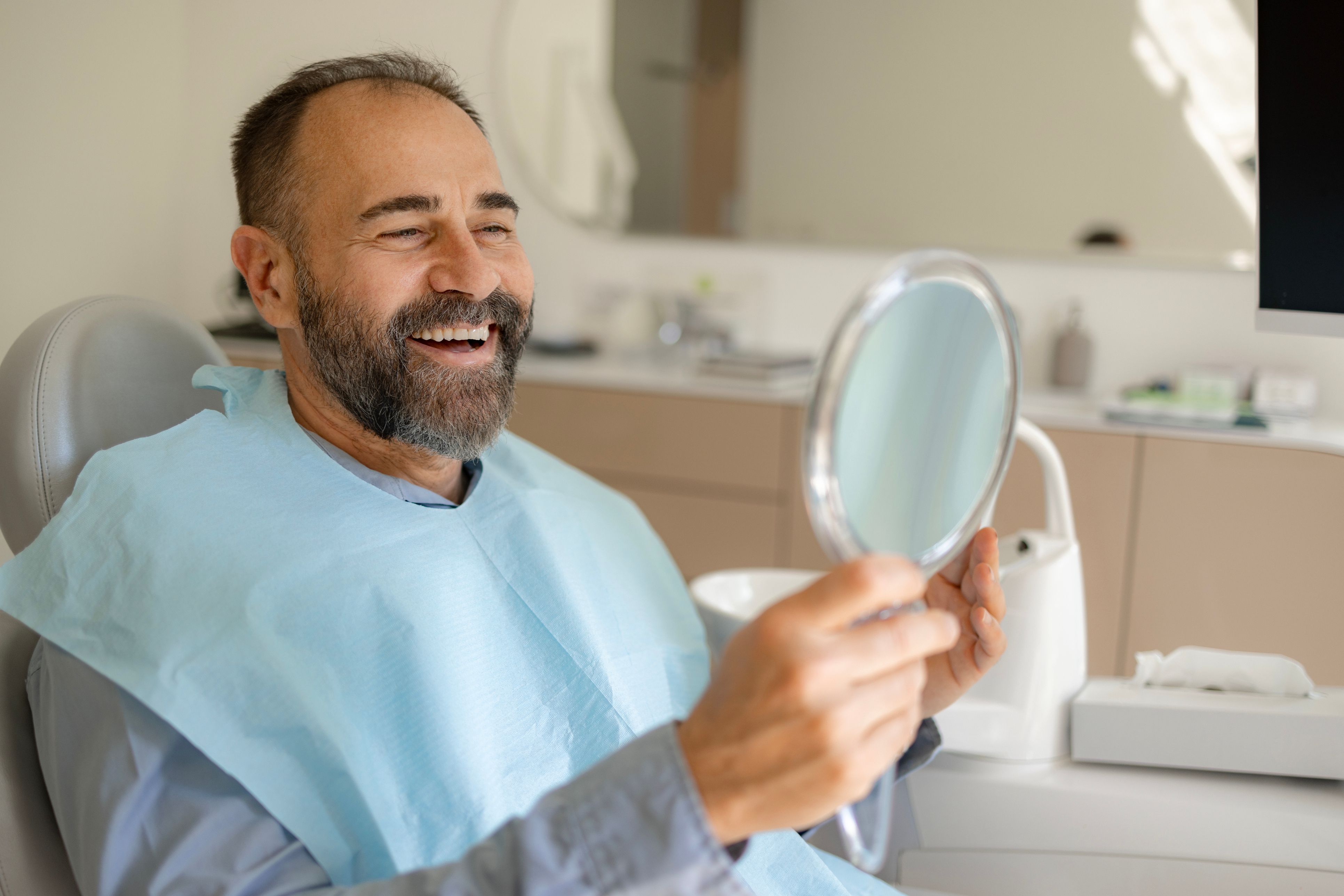 Image of a patient in an x-ray machine with his dentist.