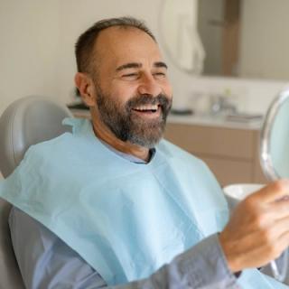 Image of a patient in an x-ray machine with his dentist.