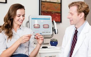 Patient talking with dentist about Invisalign treatment