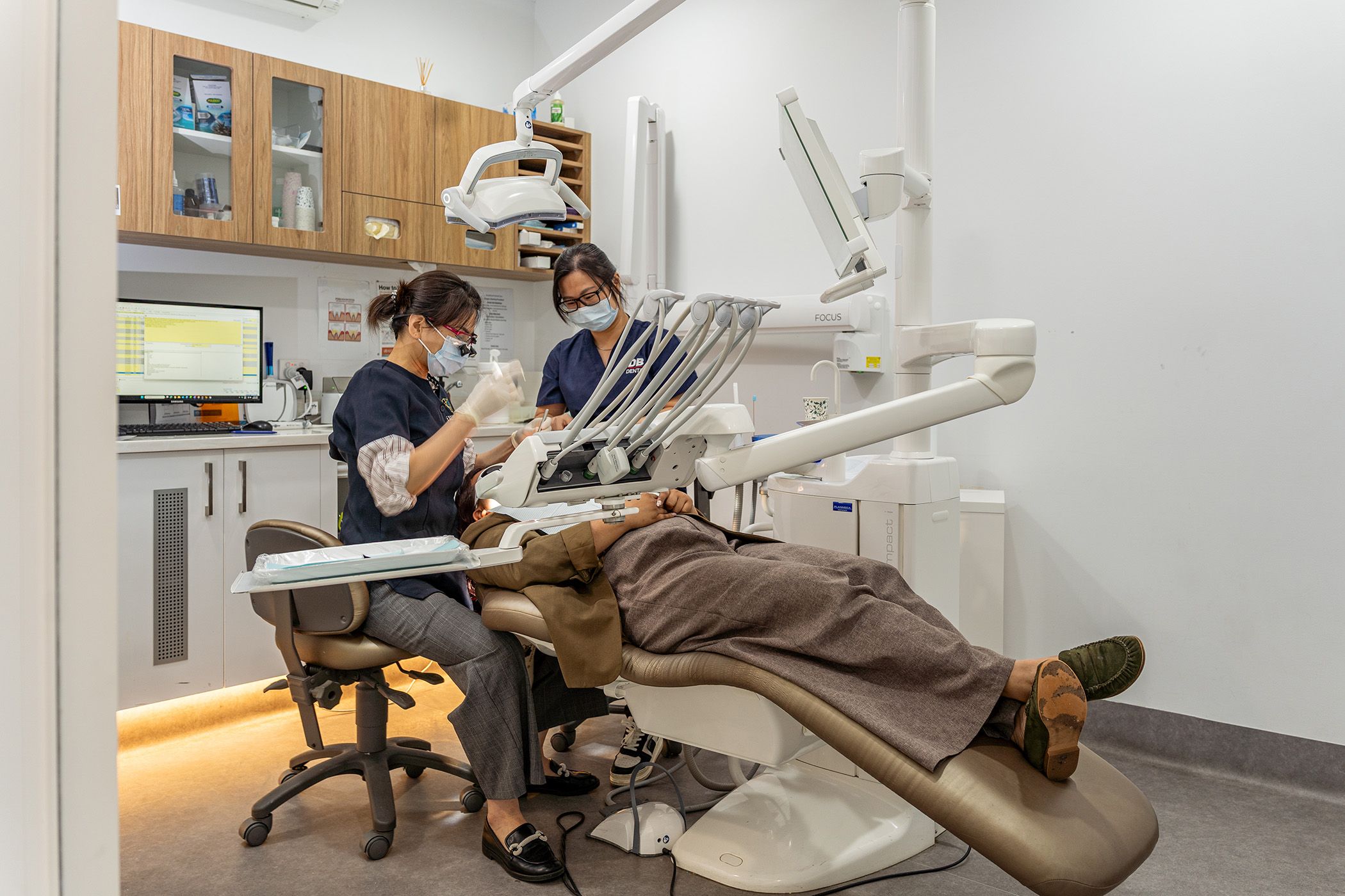 Image of our dentists caring for a patient in our dental chair at our Spearwood clinic.