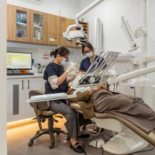 Image of our dentists caring for a patient in our dental chair at our Spearwood clinic.