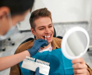 Image of a male having his teeth assessed to find the perfect shade of white.