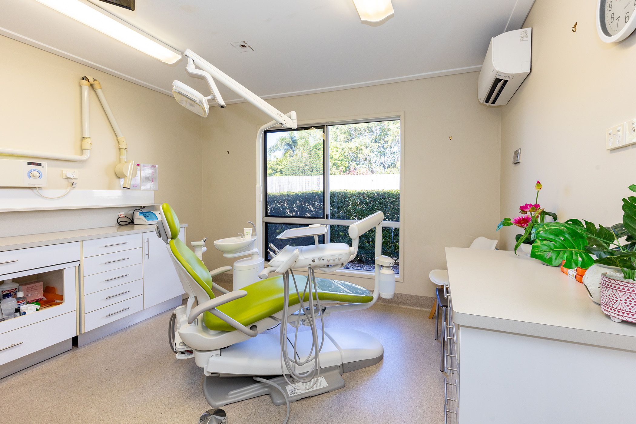 An image of our facilities, a dental chair in a calming room with a window on a sunny day.