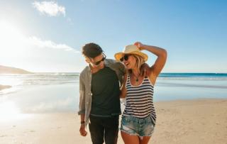 Happy couple walking on the beach