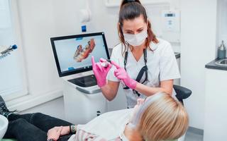 Dentist explaining the process of CEREC scanning technology