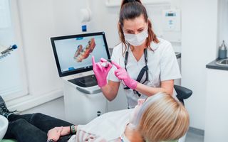 Dentist explaining the process of CEREC scanning technology