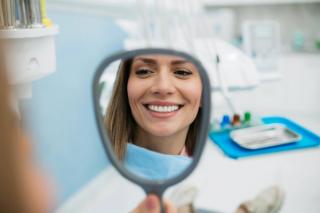 It serves the purpose of the natural tooth by: