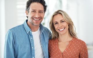 Image of a couple that both have a beautiful smile.