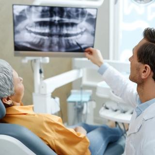 Dentist discussing patients x-ray during dental appointment