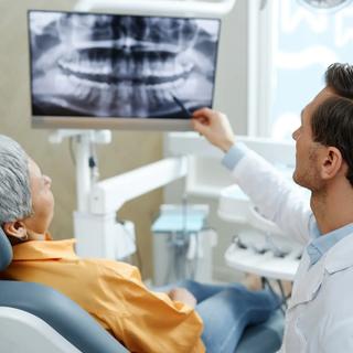 Dentist discussing patients x-ray during dental appointment