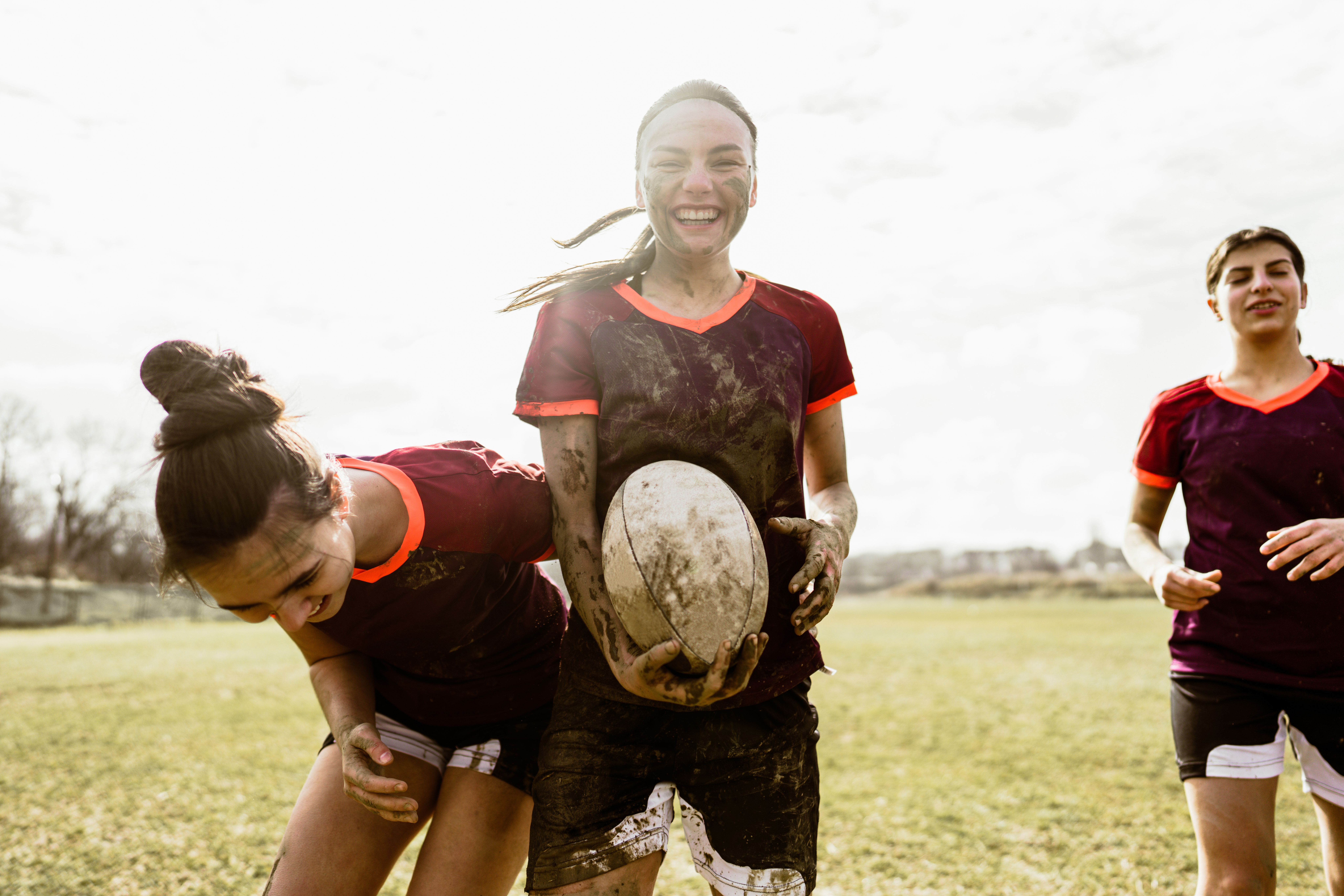 Kids in sports uniforms after a contact sports game