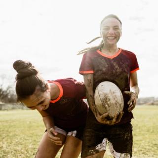 Image of a group of your girls playing rugby during daytime.