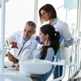 Image of a dentist with his patient talking about options on how to treat their TMJ disorder.