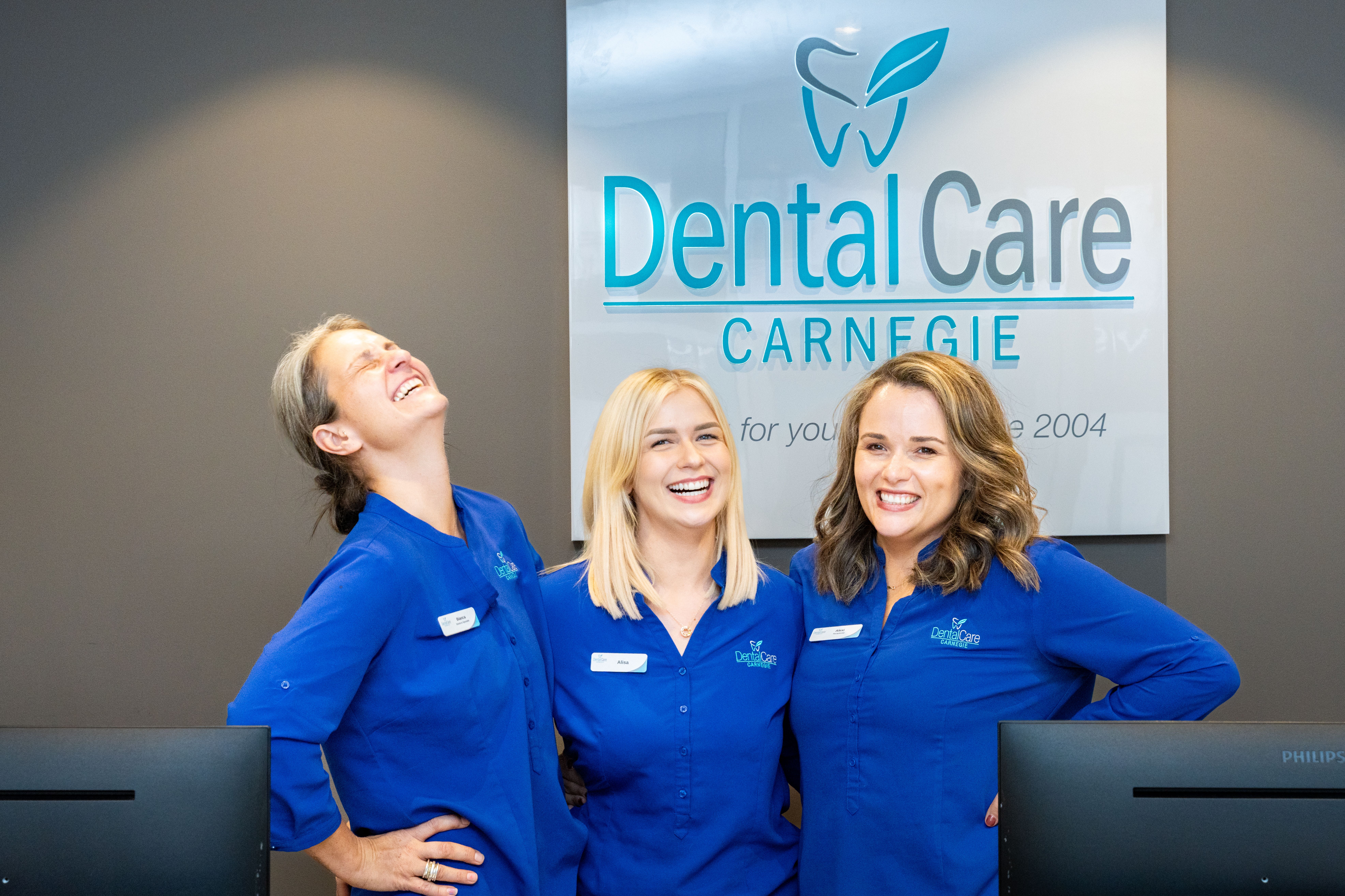 Image of the DentalCare Carnegie team in the receptionist area of the dental clinic. 