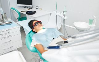Image of a women relaxing in a dentist chair.