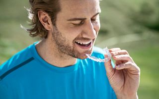 Male putting in Invisalign aligner