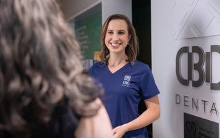 Image of our dentist welcoming her patient.