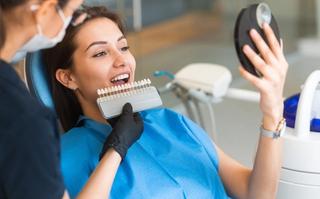 Patient inspecting their new smile post-veneers treatment