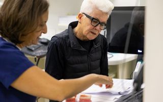 Image of our CBD Sydney dentist discussing with her patient.
