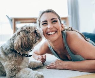 Female enjoying with white teeth at home