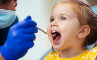 Dentist with a young patient undergoing a dental check-up