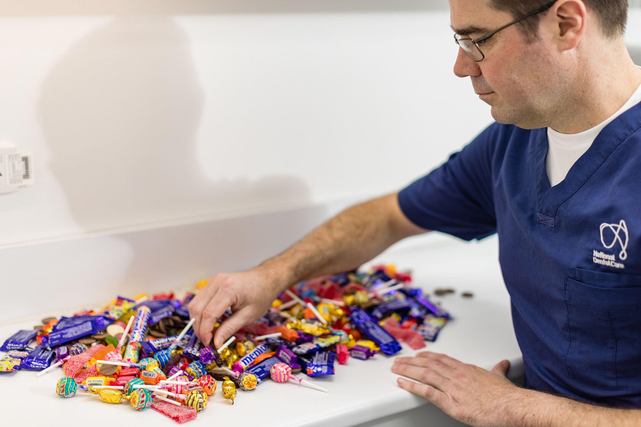 Image of Dr Antony Benedetto searching through an assortment of lollies.