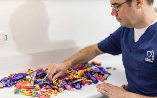 Image of Dr Antony Benedetto searching through an assortment of lollies.