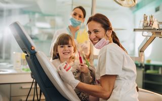 Image of a dentist checking his patient's teeth.