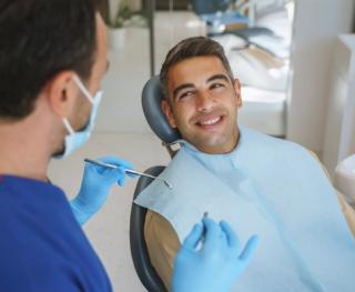 Image of male with a dentist discussing his teeth whitening plan.