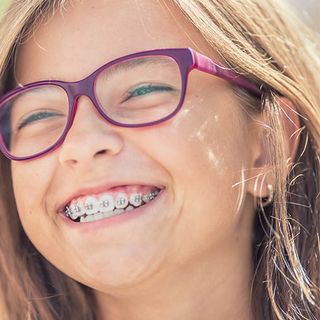 A child with orthodontic braces enjoying the sunny day.