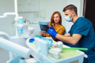 Image of a patient with her dentist at a dental clinic.