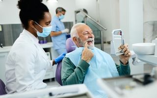 Patient happily looking in mirror post-treatment