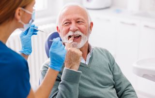 Senior male with dentist discussing treatment