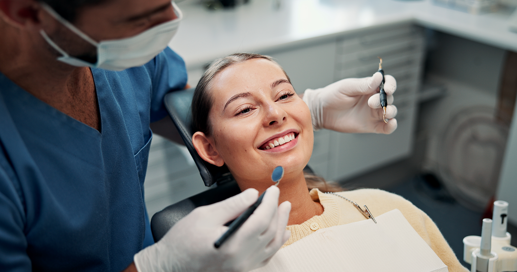 Image of a dentist answering questions for a patient at her dental clinic.