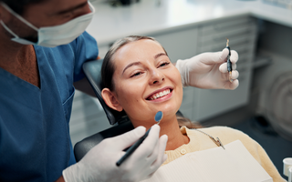 Image of a dentist answering questions for a patient at her dental clinic.