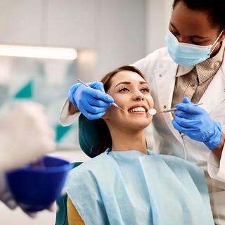 Patient having a scale, clean and polish at the dentist