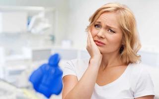 Female showing signs of dental related discomfort