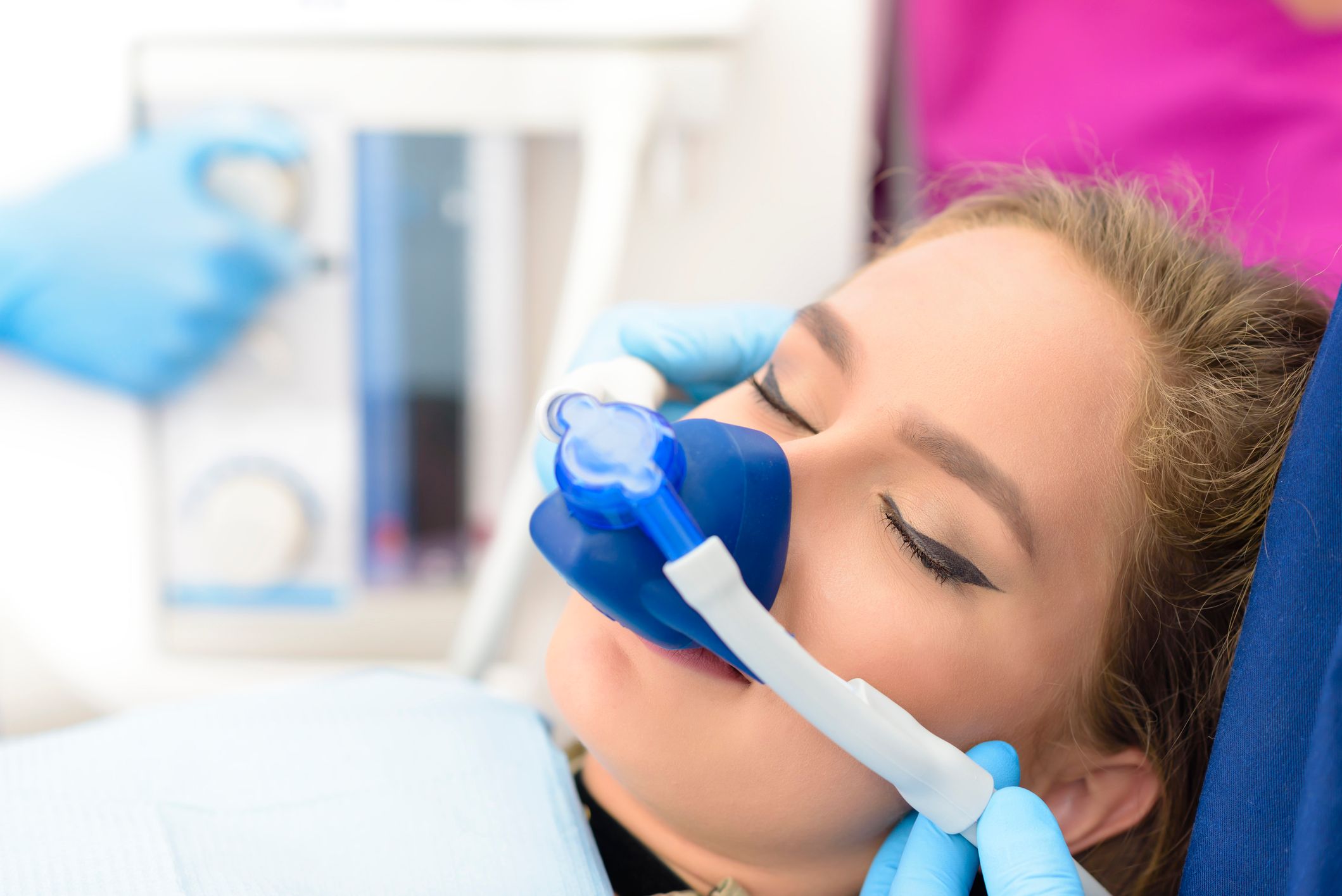 Image of a blonde woman undergoing sleep dentistry.