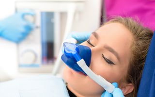 Image of a blonde woman undergoing sleep dentistry.